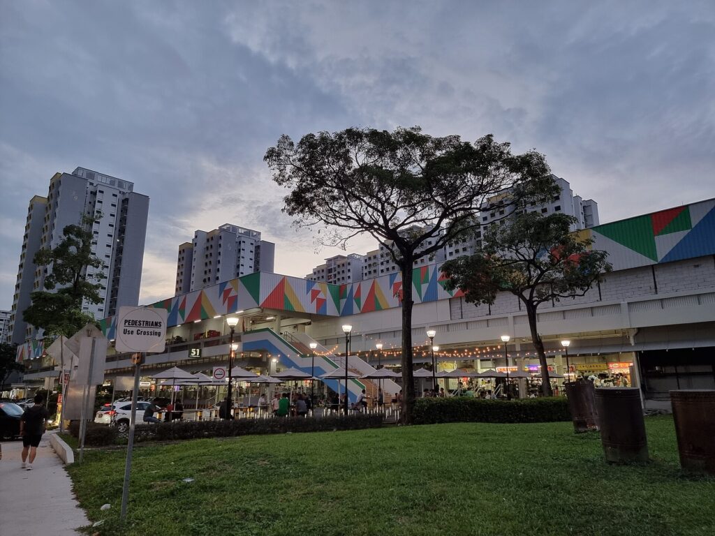 51 Old Airport Road Food Centre at dusk, with nearby HDB blocks